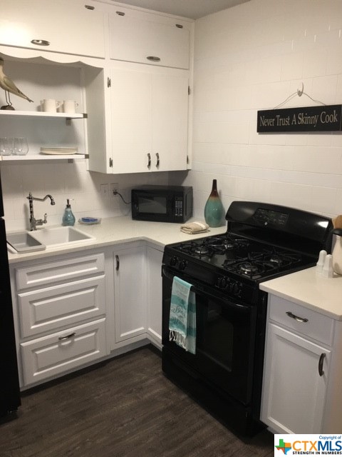 a kitchen with a stove and a cabinets