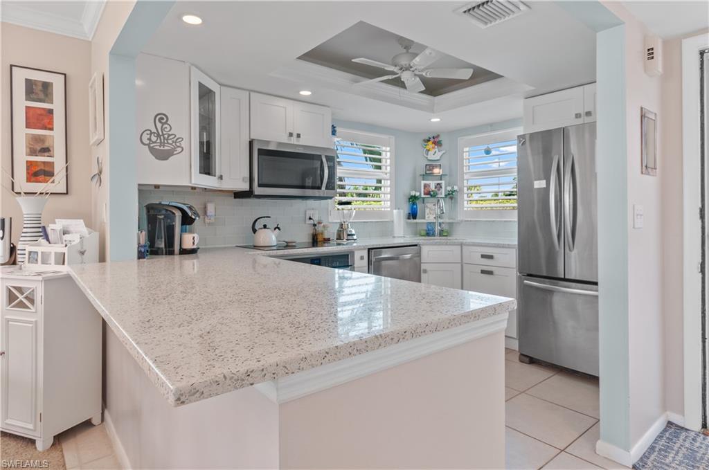 37 High Point Circle East, Unit 210 Naples, FL 34103 - Photo 1 of 29 a kitchen with stainless steel appliances granite countertop a refrigerator a sink a stove top oven a refrigerator and white cabinets