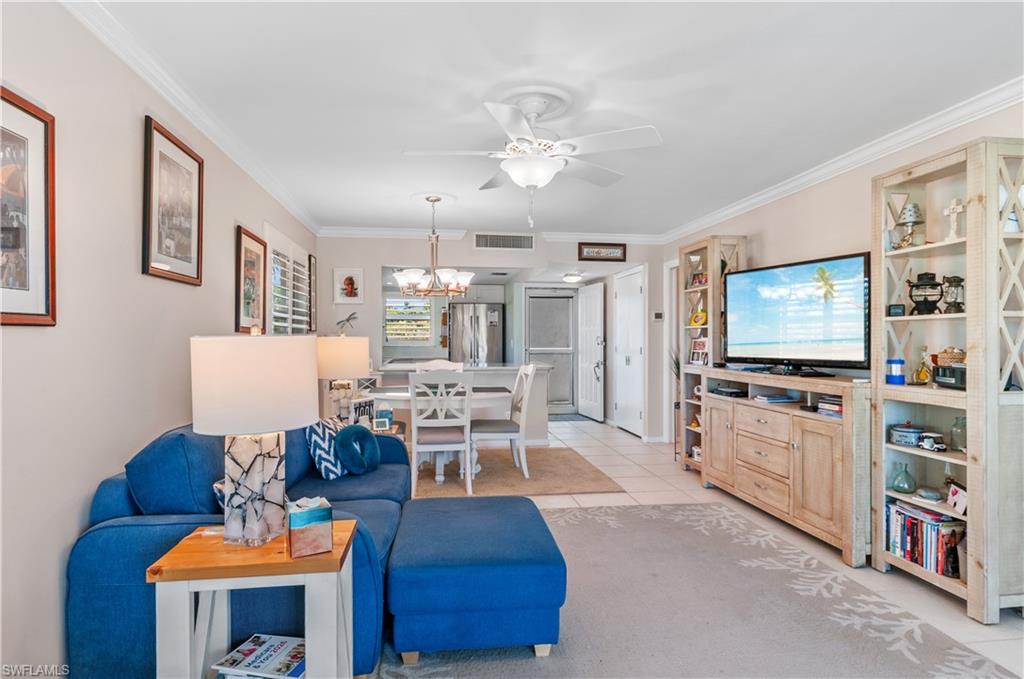 37 High Point Circle East, Unit 210 Naples, FL 34103 - Photo 11 of 29 a living room with furniture and a flat screen tv