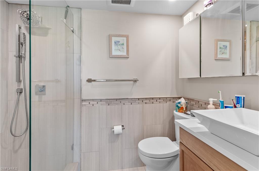 37 High Point Circle East, Unit 210 Naples, FL 34103 - Photo 14 of 29 a bathroom with a sink a toilet and shower
