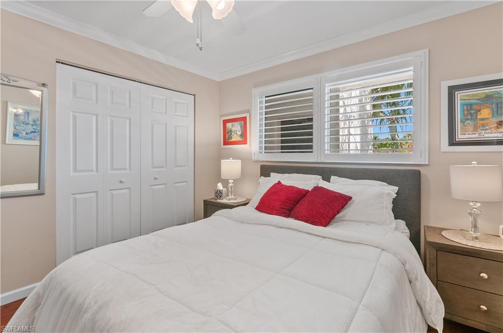 37 High Point Circle East, Unit 210 Naples, FL 34103 - Photo 18 of 29 a bedroom with a large bed and a closet