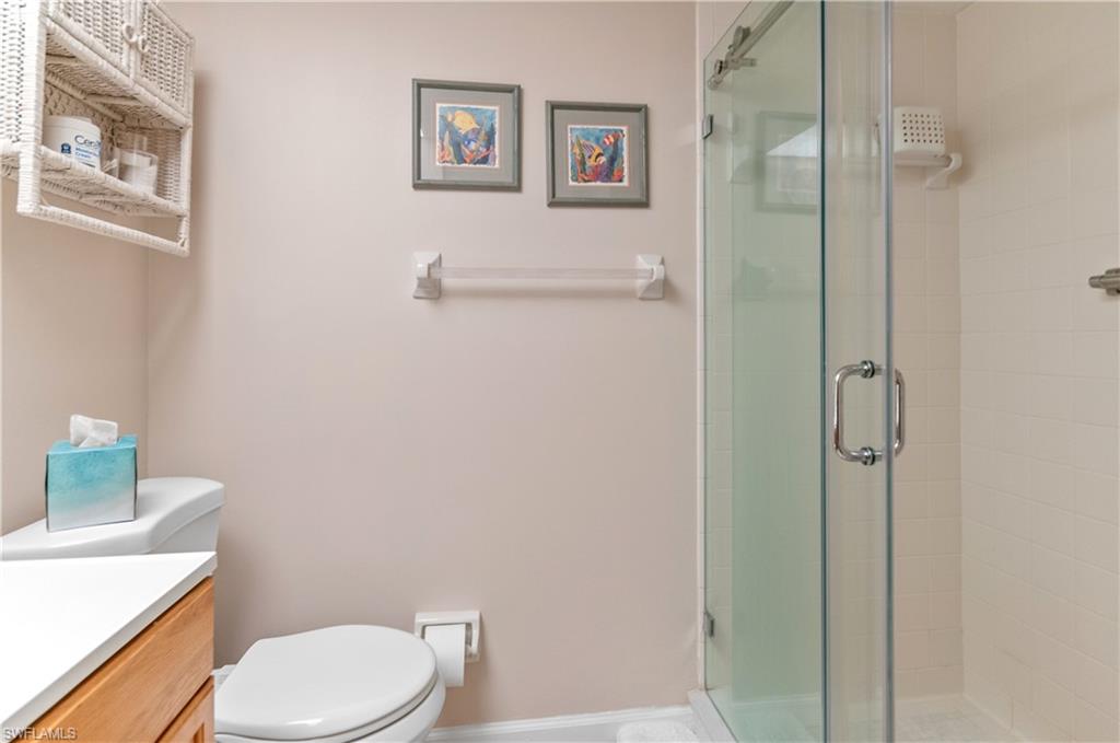 37 High Point Circle East, Unit 210 Naples, FL 34103 - Photo 19 of 29 a white toilet sitting next to a bathroom sink