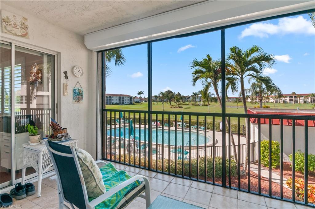 37 High Point Circle East, Unit 210 Naples, FL 34103 - Photo 20 of 29 a view of a balcony with lake and outdoor seating