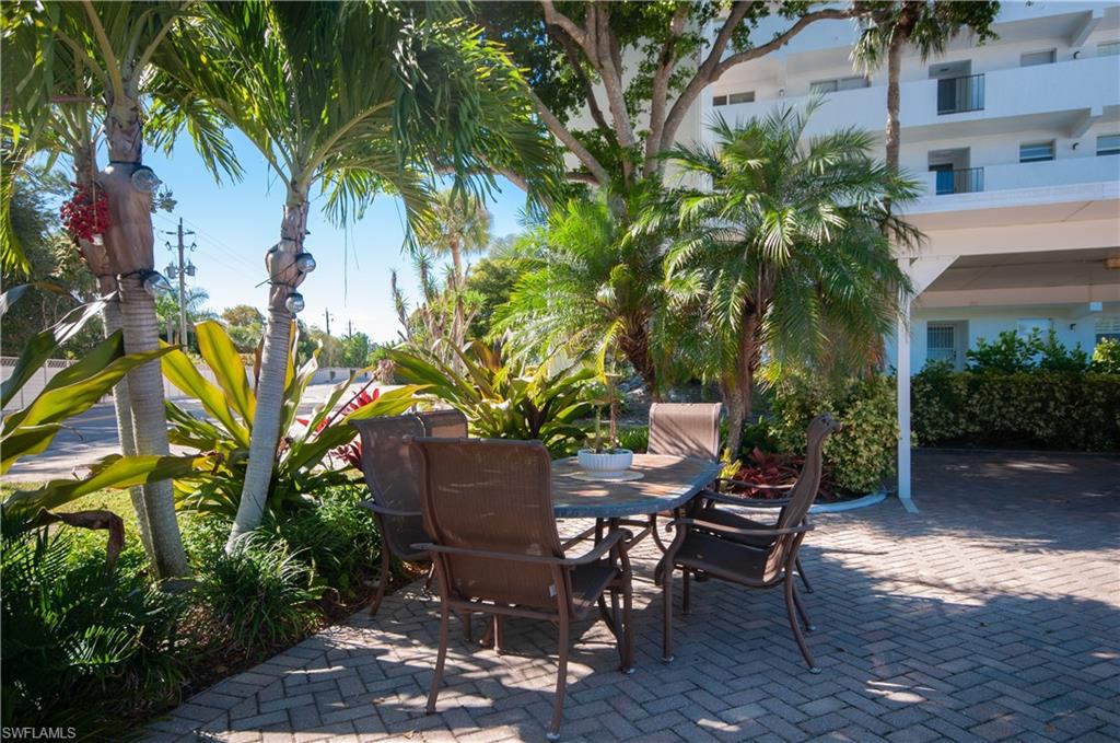37 High Point Circle East, Unit 210 Naples, FL 34103 - Photo 23 of 29 a view of a backyard with plants and sitting area