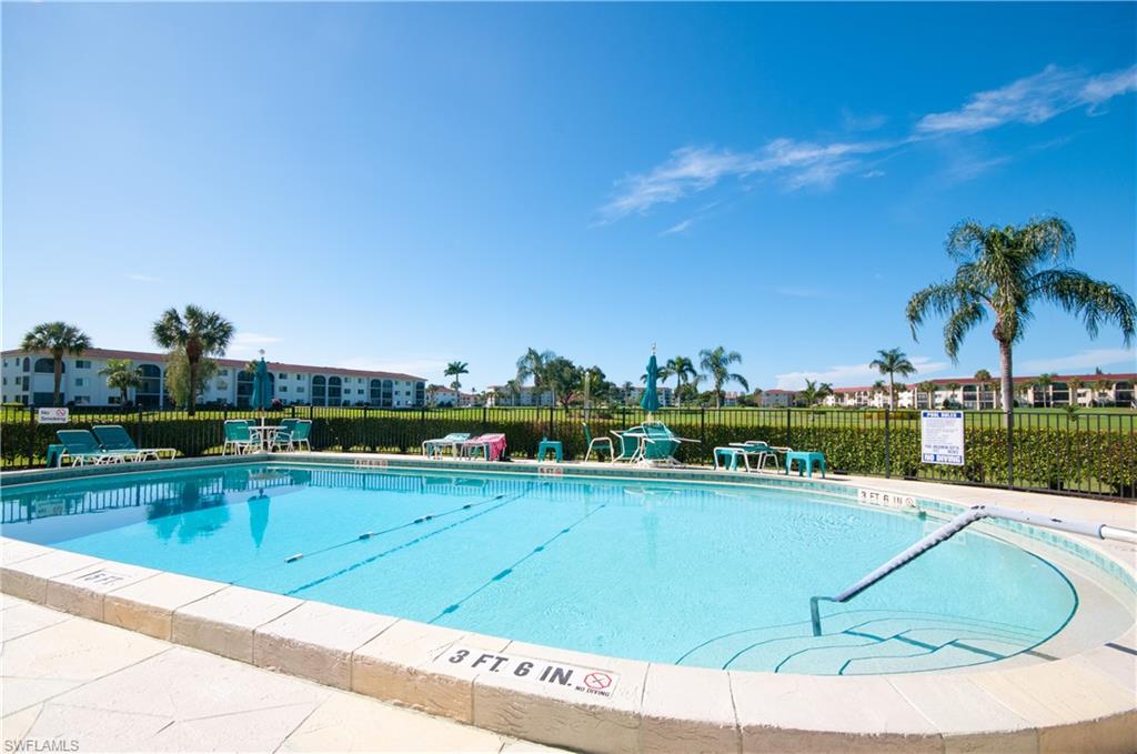 37 High Point Circle East, Unit 210 Naples, FL 34103 - Photo 24 of 29 a view of a swimming pool and an outdoor seating