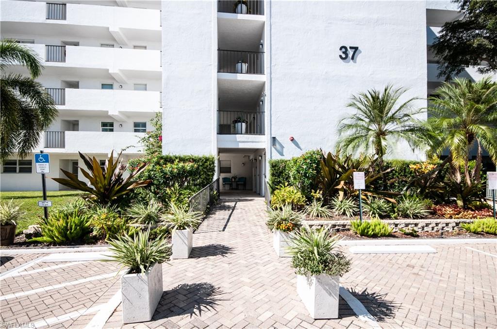 37 High Point Circle East, Unit 210 Naples, FL 34103 - Photo 27 of 29 a potted plant sitting in front of a house