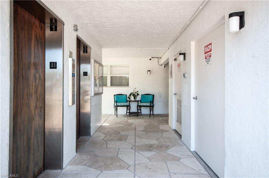 37 High Point Circle East, Unit 210 Naples, FL 34103 - Photo 29 of 29 a view of a hallway with dining area and glass doors