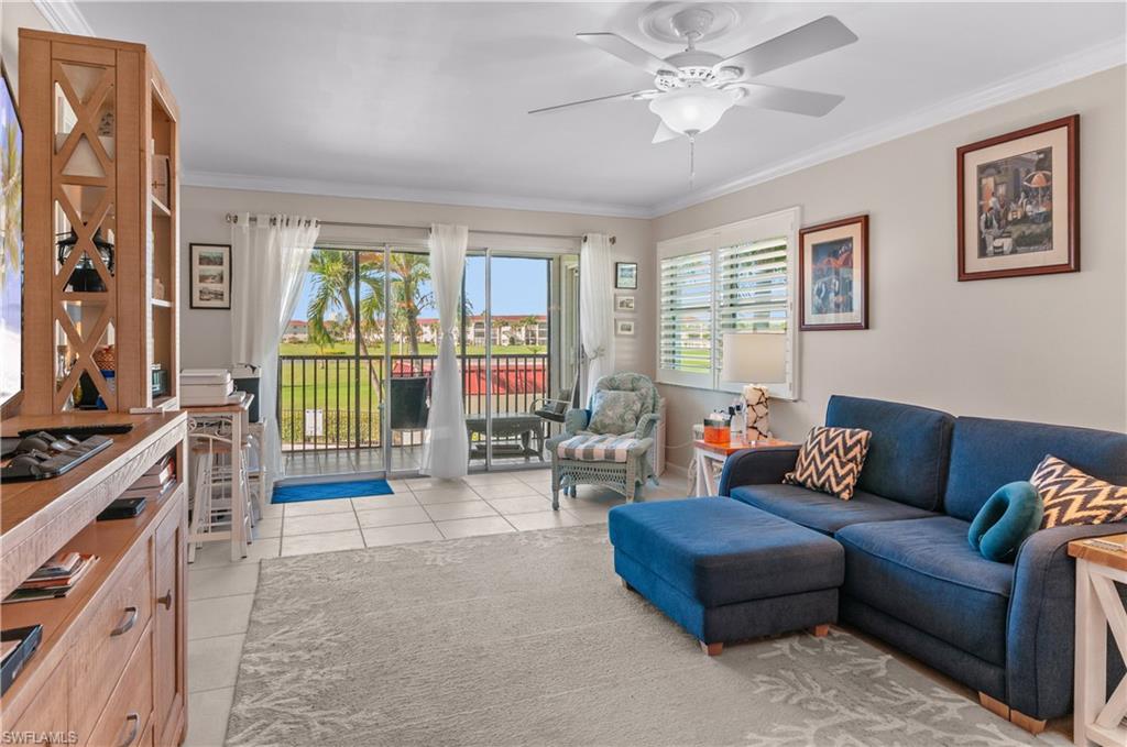 37 High Point Circle East, Unit 210 Naples, FL 34103 - Photo 9 of 29 a living room with furniture and a flat screen tv