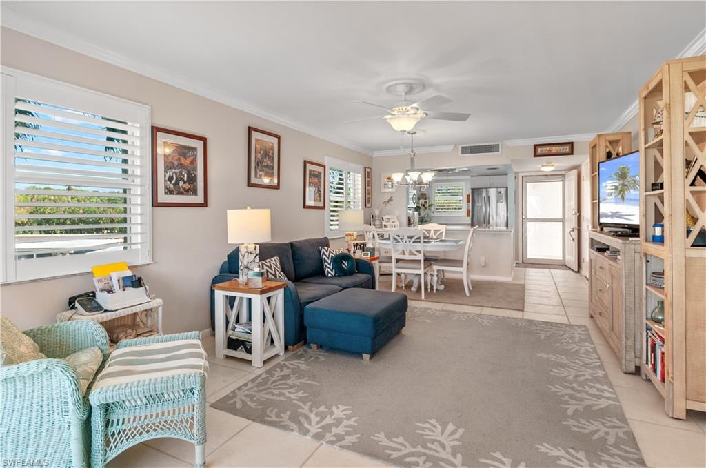 37 High Point Circle East, Unit 210 Naples, FL 34103 - Photo 10 of 29 a living room with furniture and a window