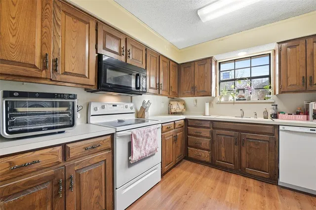 a kitchen with stainless steel appliances granite countertop a stove sink microwave and cabinets