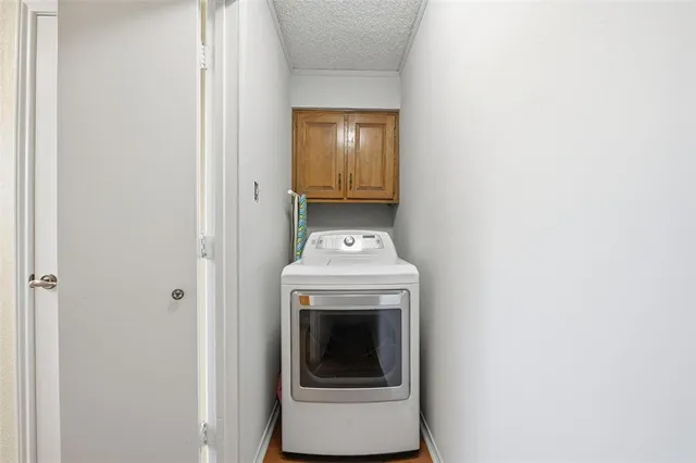 a view of a hallway with washer and dryer