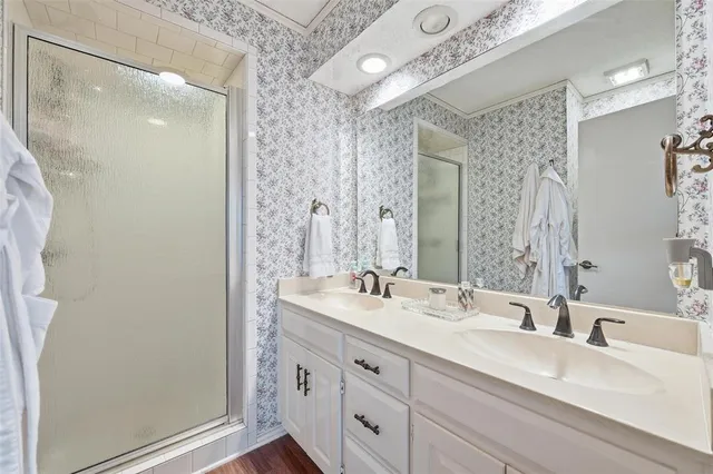 a bathroom with a double vanity sink and a mirror