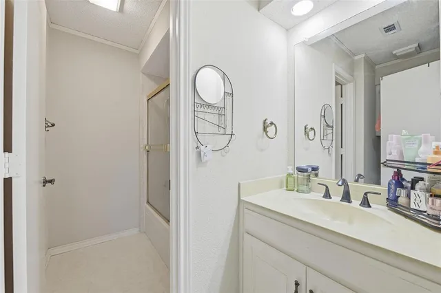 a bathroom with a double vanity sink mirror and shower