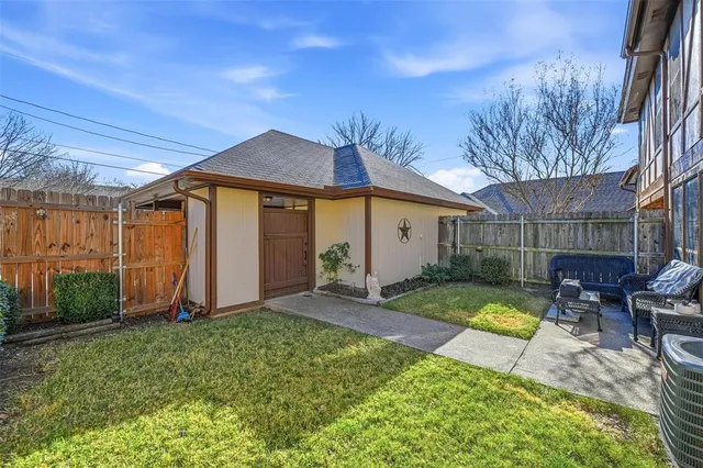 a view of a backyard with table and chairs under an umbrella