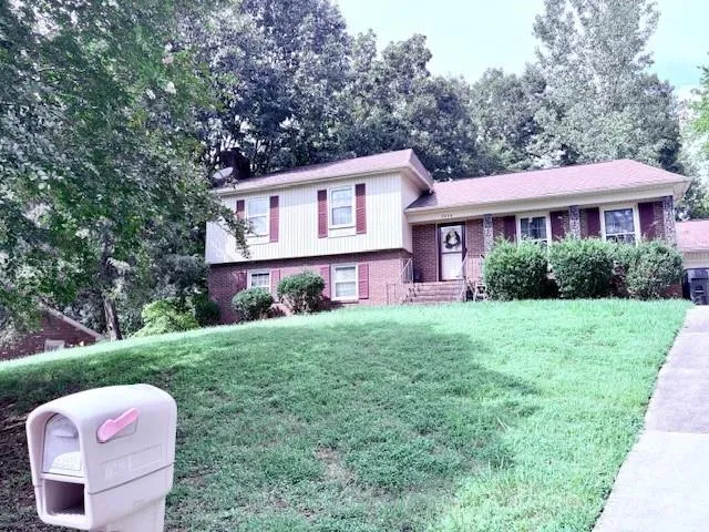 a view of a house with yard and a garden