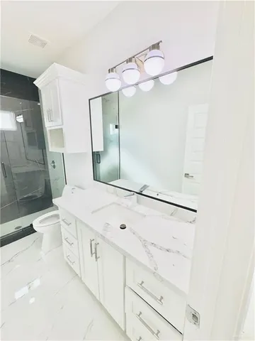 a bathroom with a sink a mirror and a shower