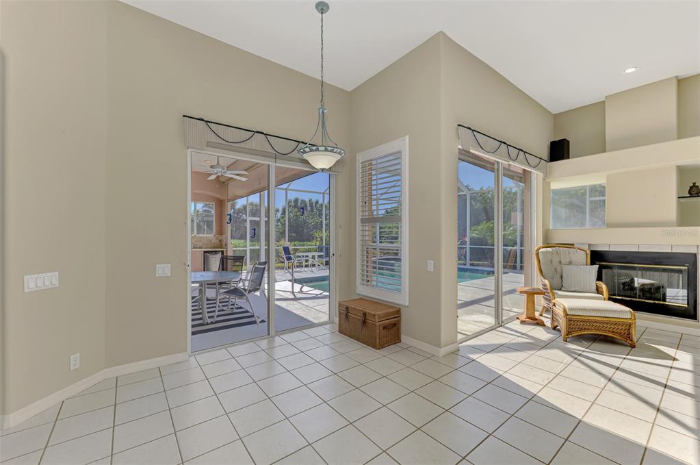 3634 Pennyroyal Road Port Charlotte, FL 33953 - Photo 16 of 91 a living room with furniture a flat screen tv and a fireplace