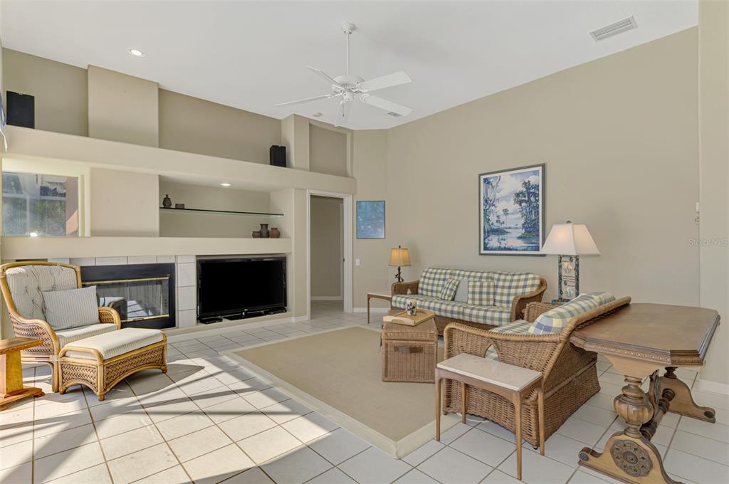 3634 Pennyroyal Road Port Charlotte, FL 33953 - Photo 17 of 91 a living room with furniture a fireplace and a table