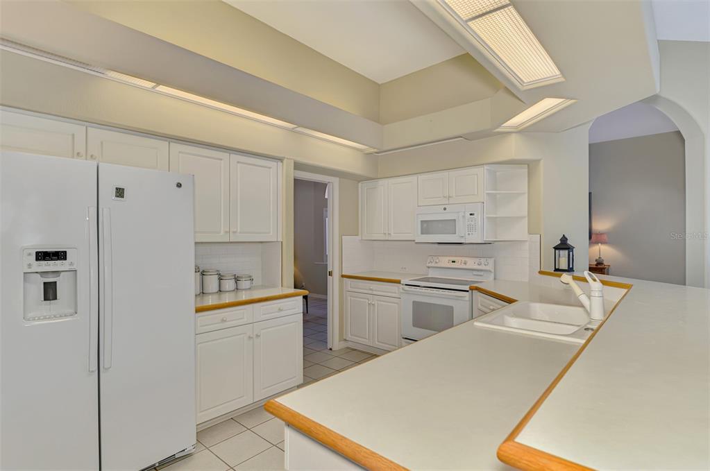 3634 Pennyroyal Road Port Charlotte, FL 33953 - Photo 26 of 91 a kitchen with a sink a stove and refrigerator