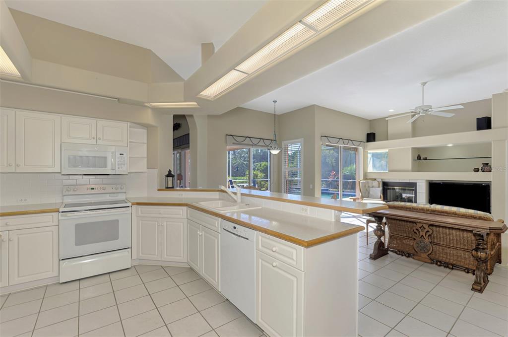 3634 Pennyroyal Road Port Charlotte, FL 33953 - Photo 27 of 91 a kitchen with a stove a sink and a refrigerator