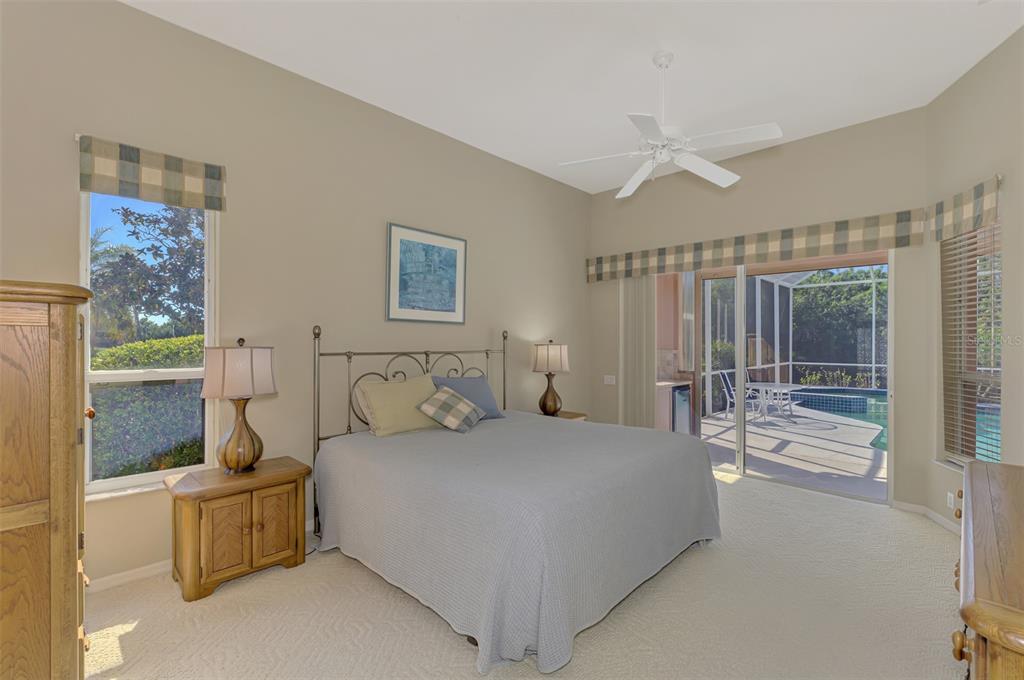 3634 Pennyroyal Road Port Charlotte, FL 33953 - Photo 31 of 91 a bedroom with a large bed and a chandelier