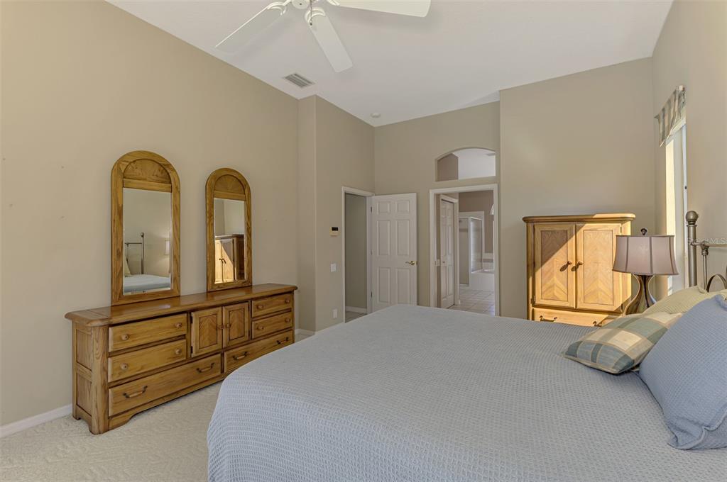 3634 Pennyroyal Road Port Charlotte, FL 33953 - Photo 34 of 91 a bedroom with a bed and a painting on the wall
