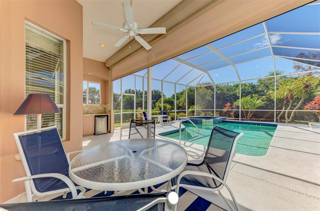 3634 Pennyroyal Road Port Charlotte, FL 33953 - Photo 47 of 91 a view of a patio with table and chairs under an umbrella