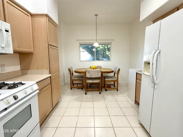 a kitchen with a refrigerator a sink and cabinets