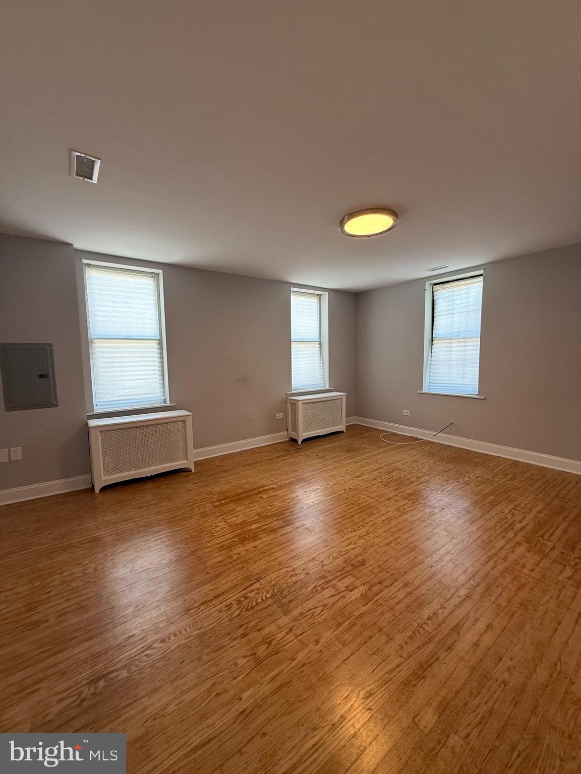 1208 Mifflin Street, Unit 2 Philadelphia, PA 19148 - Photo 11 of 14 a view of empty room with wooden floor and fan