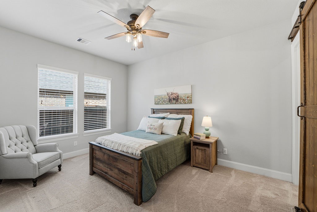 3618 Edison Lane Iowa Colony, TX 77583 - Photo 26 of 50 a spacious bedroom with a bed a couch and a window