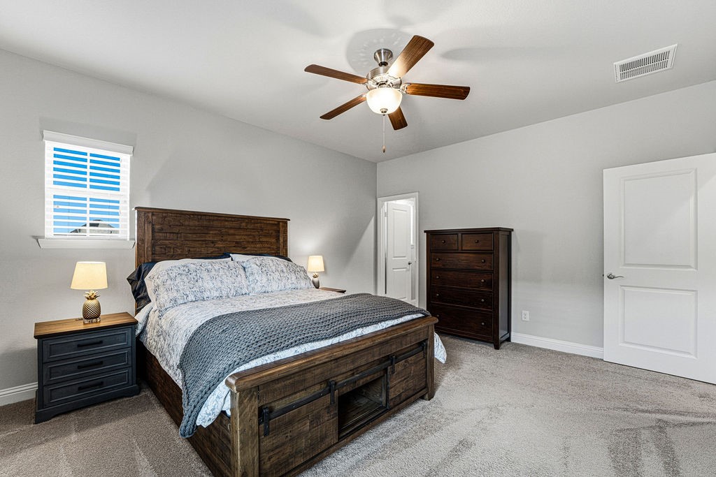 3618 Edison Lane Iowa Colony, TX 77583 - Photo 29 of 50 a bedroom with a bed and a chandelier