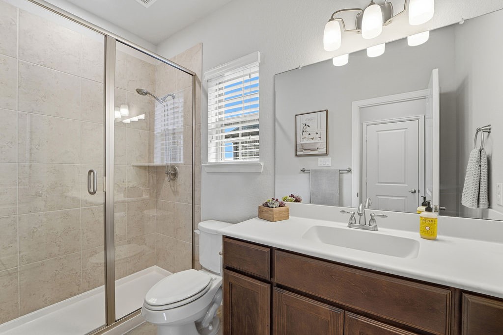 3618 Edison Lane Iowa Colony, TX 77583 - Photo 30 of 50 a bathroom with a sink a toilet and a large mirror