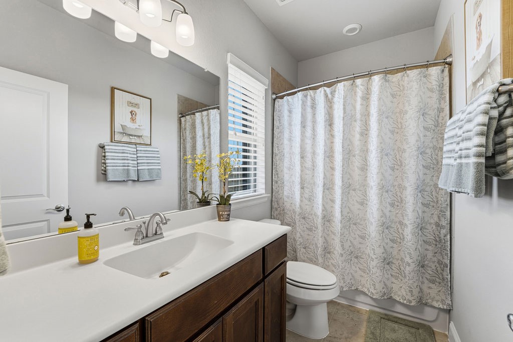 3618 Edison Lane Iowa Colony, TX 77583 - Photo 32 of 50 a bathroom with a sink a toilet and a mirror