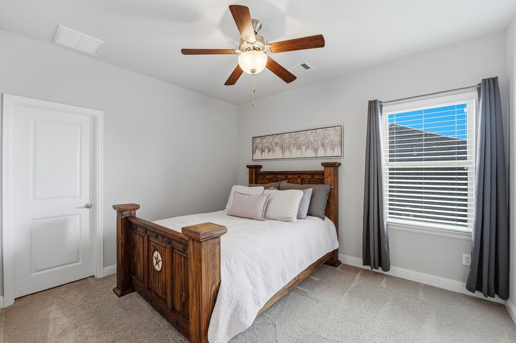 3618 Edison Lane Iowa Colony, TX 77583 - Photo 33 of 50 a bedroom with a bed and a ceiling fan