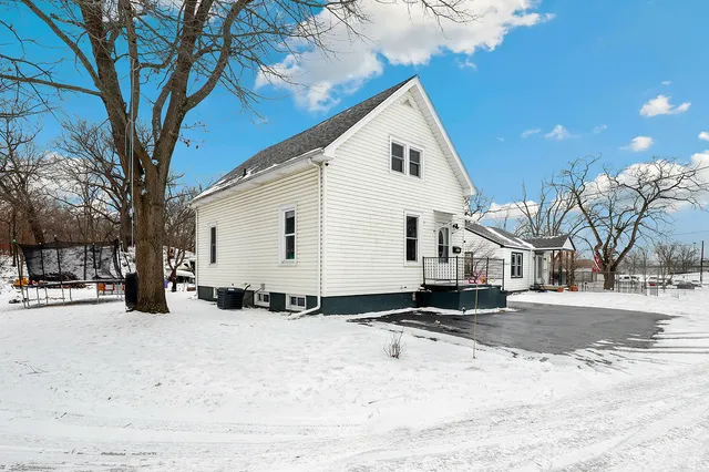 a view of a white house covered in snow
