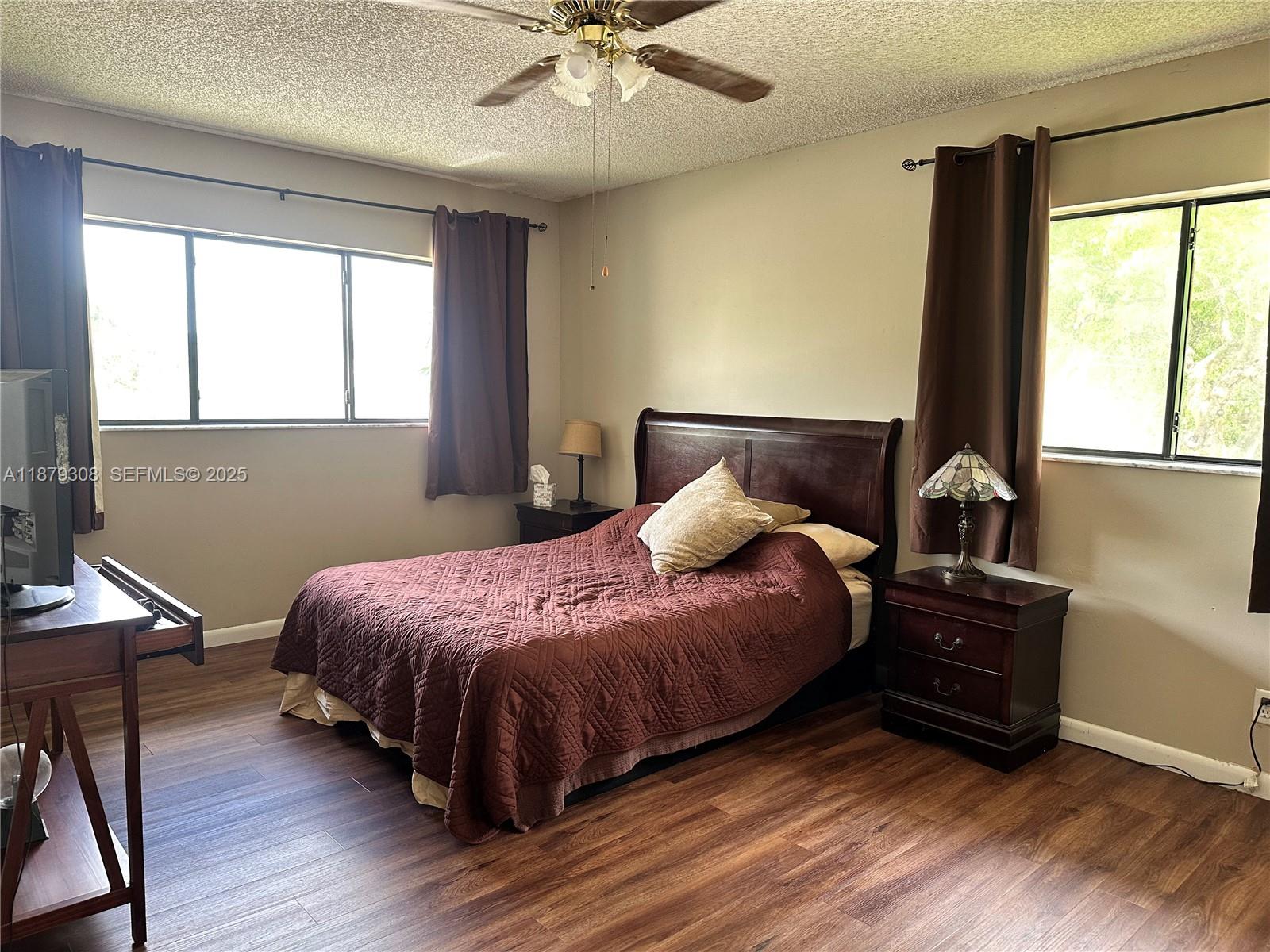 19700 Southwest 103rd Court, Unit 201 Cutler Bay, FL 33157 - Photo 12 of 21 a bedroom with a bed and a window