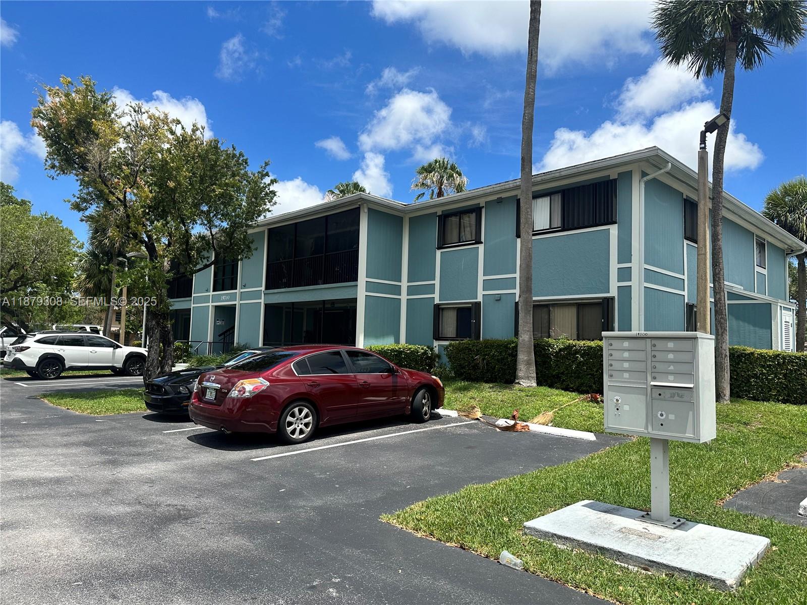 19700 Southwest 103rd Court, Unit 201 Cutler Bay, FL 33157 - Photo 20 of 21 a front view of a house with a yard garage and outdoor seating