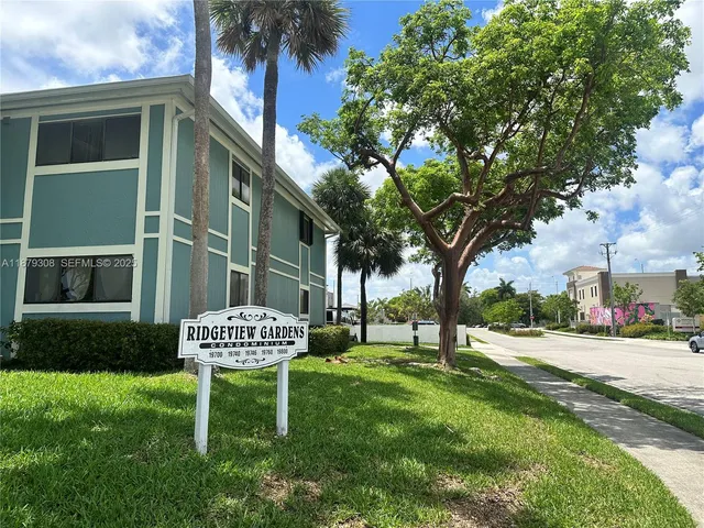 a view of a chair and table in backyard of the house