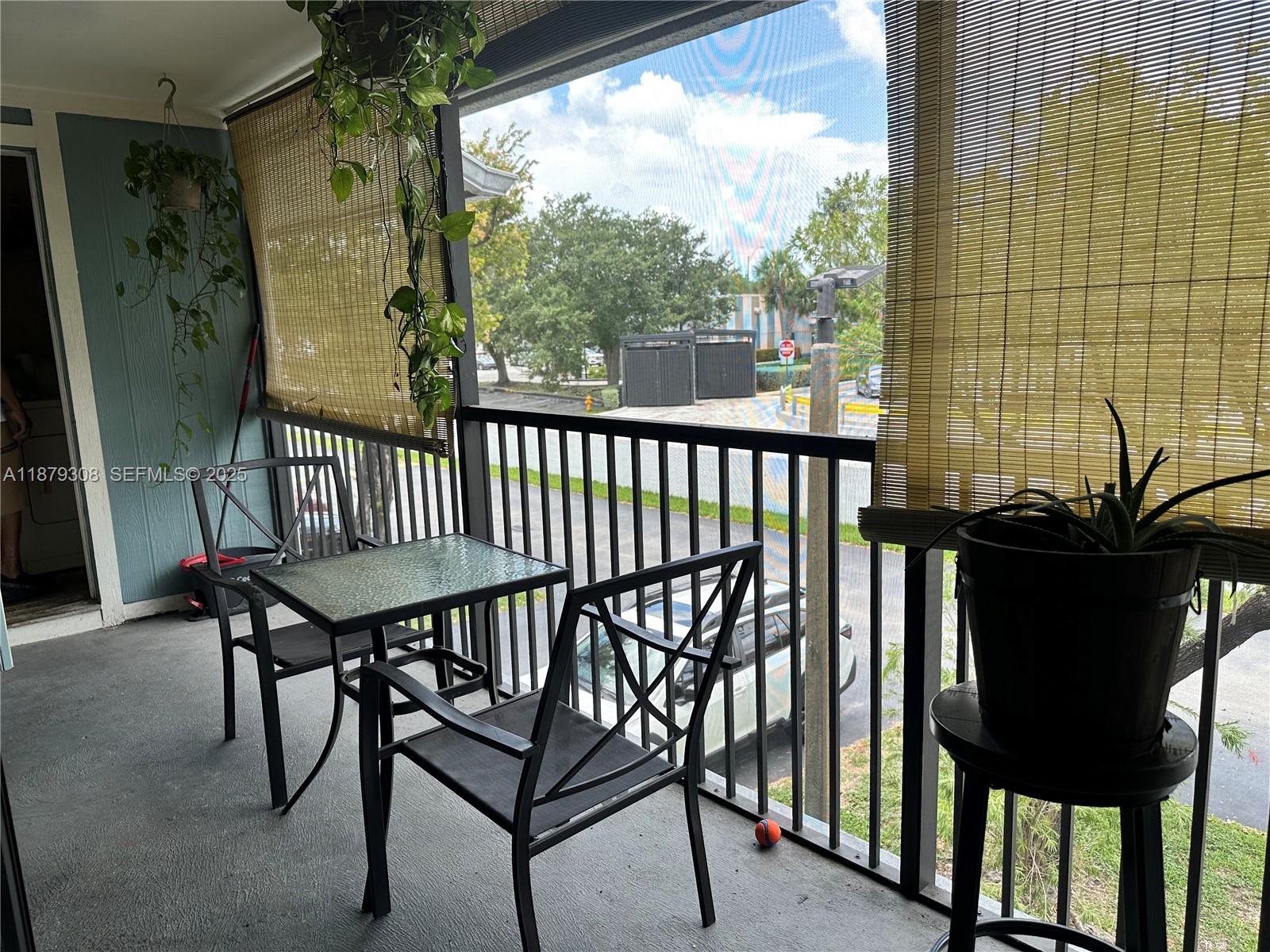 19700 Southwest 103rd Court, Unit 201 Cutler Bay, FL 33157 - Photo 3 of 21 a view of a chairs and table in the balcony