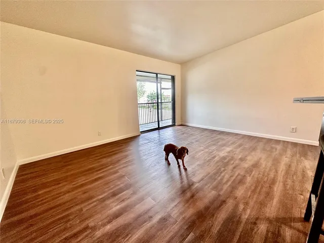 a view of a room with wooden floor