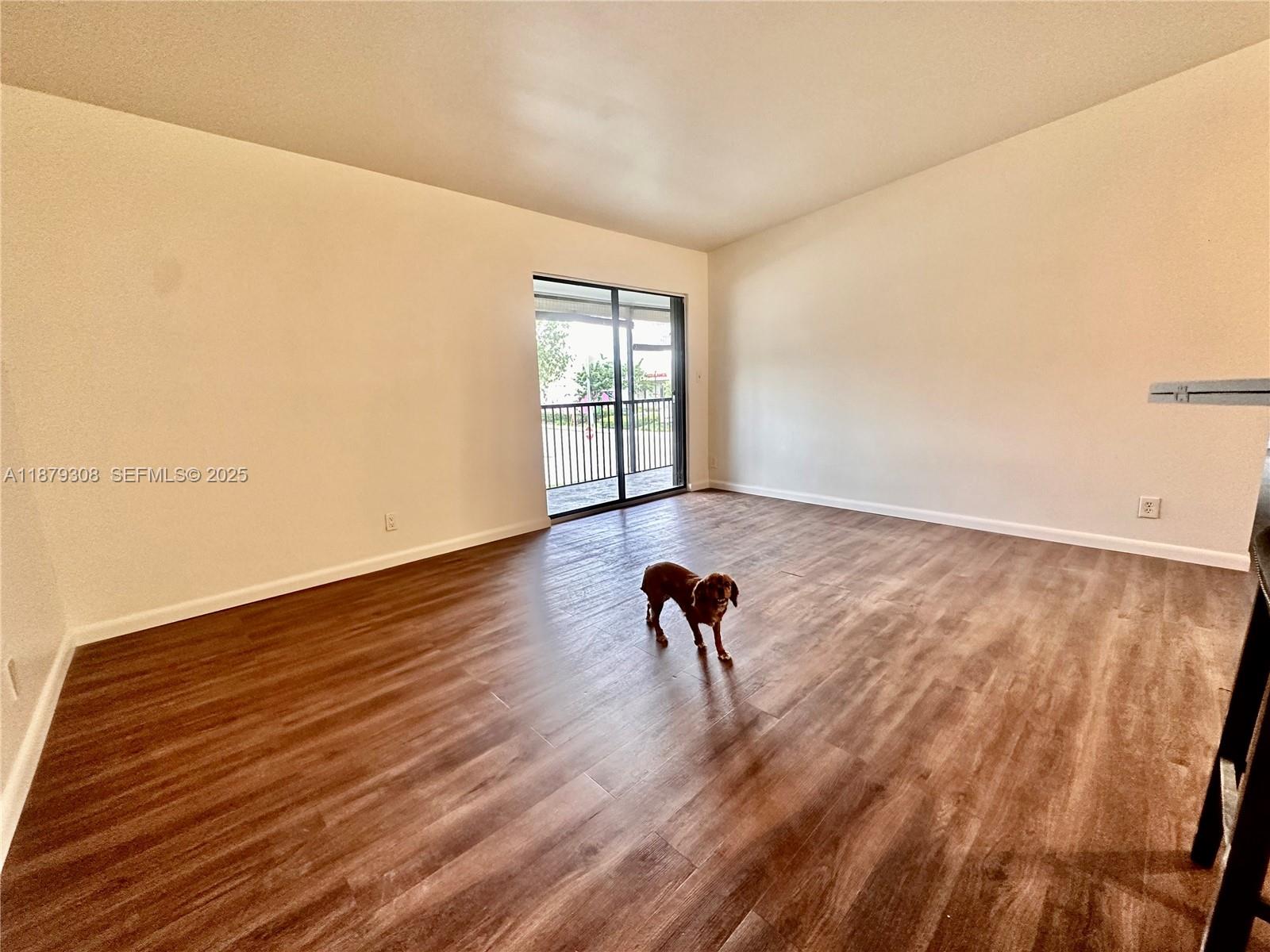 19700 Southwest 103rd Court, Unit 201 Cutler Bay, FL 33157 - Photo 5 of 21 a view of a room with wooden floor