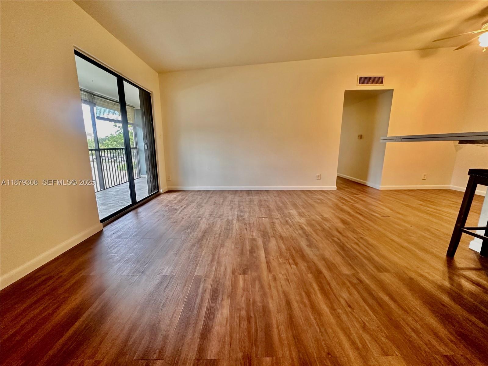 19700 Southwest 103rd Court, Unit 201 Cutler Bay, FL 33157 - Photo 6 of 21 wooden floor in an empty room with a window
