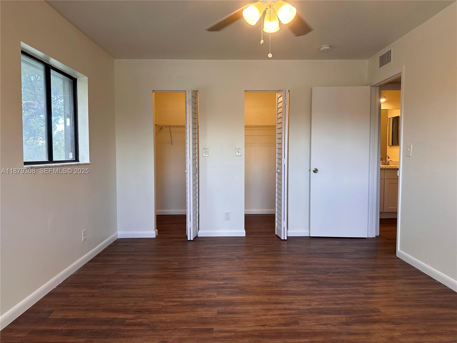 19700 Southwest 103rd Court, Unit 201 Cutler Bay, FL 33157 - Photo 10 of 21 an empty room with wooden floor and windows
