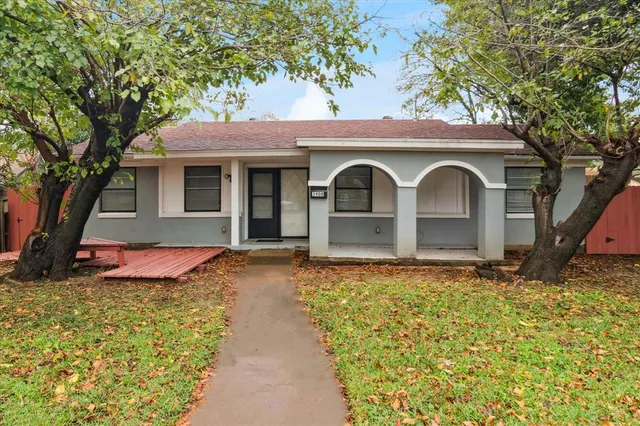 a front view of a house with yard