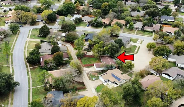 an aerial view of residential houses with outdoor space and street view