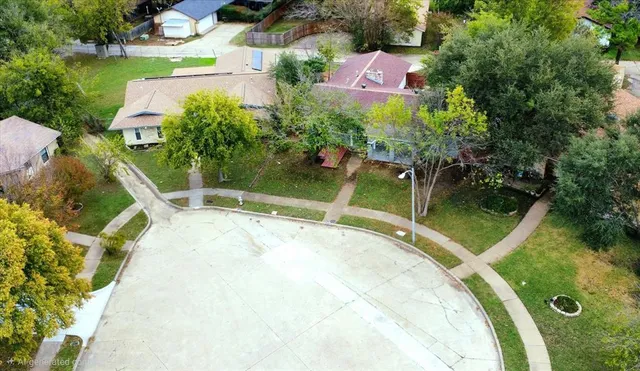 an aerial view of a house with a yard and a fountain