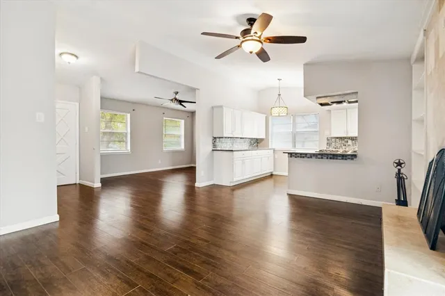 a view of a kitchen with stove and wooden floor
