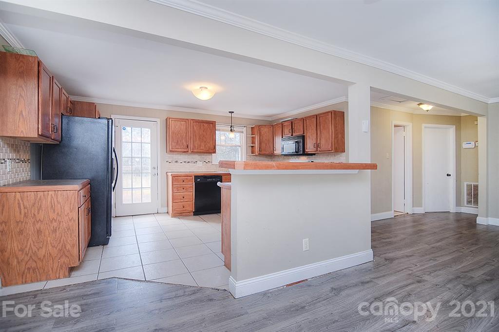 1100 Culp Street Lancaster, SC 29720 - Photo 11 of 30 a kitchen with granite countertop a stove top oven and cabinets