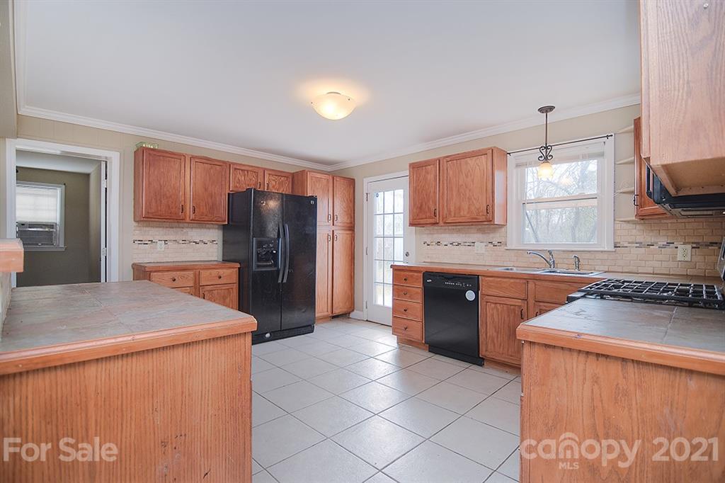 1100 Culp Street Lancaster, SC 29720 - Photo 12 of 30 a kitchen with stainless steel appliances granite countertop a refrigerator sink stove and oven