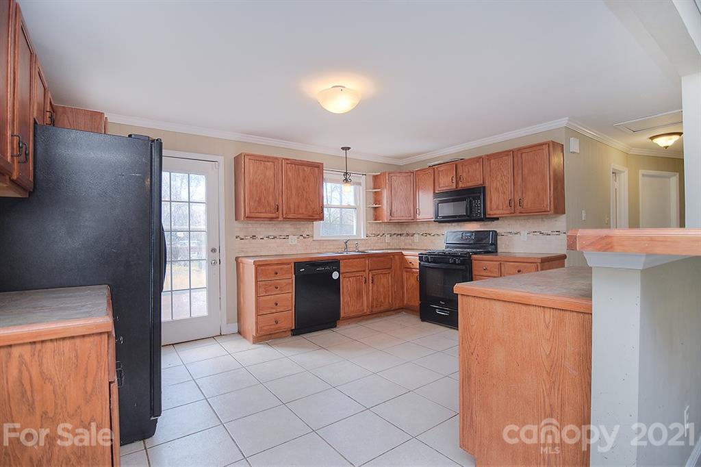 1100 Culp Street Lancaster, SC 29720 - Photo 13 of 30 a large kitchen with granite countertop a stove a sink dishwasher and a refrigerator